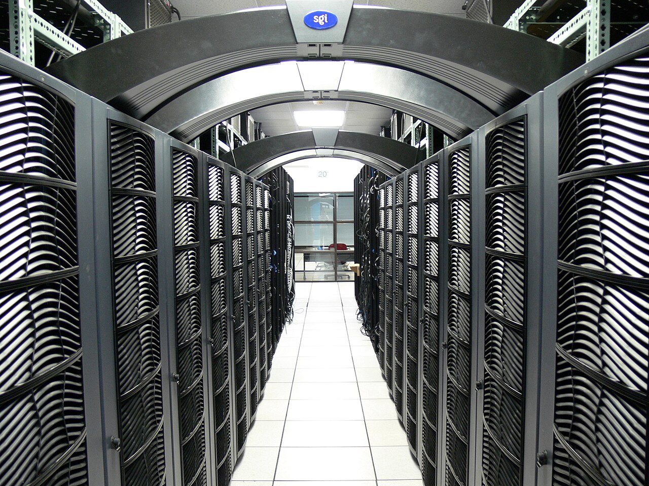 Rows of servers and network cabling in a data center room